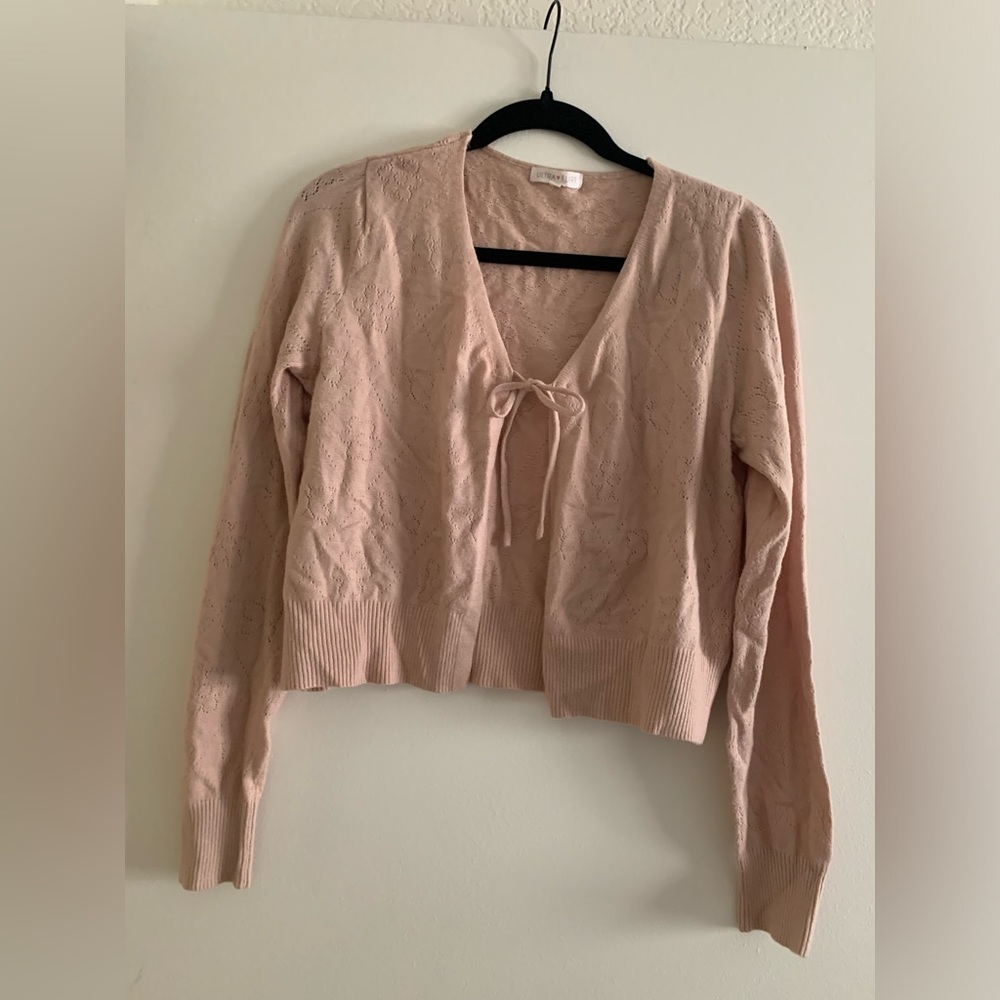 Size medium cardigan. Tie in front. Flower/butterfly detail